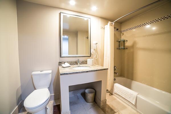 The Deluxe King Room has a beautifully crafted natural stone bathroom with a shower/tub combo.